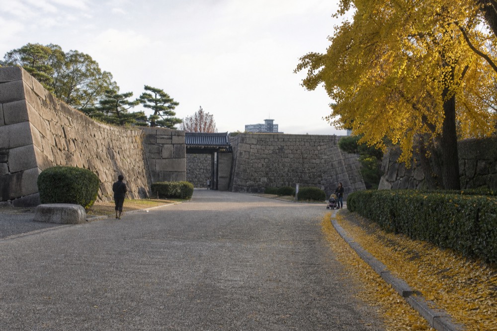 A wooden Gozabune boat on the inner moat with the Osaka Castle tower in the background