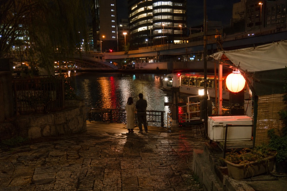 Evening crowds and neon signs along the Dotonbori canal in Osaka