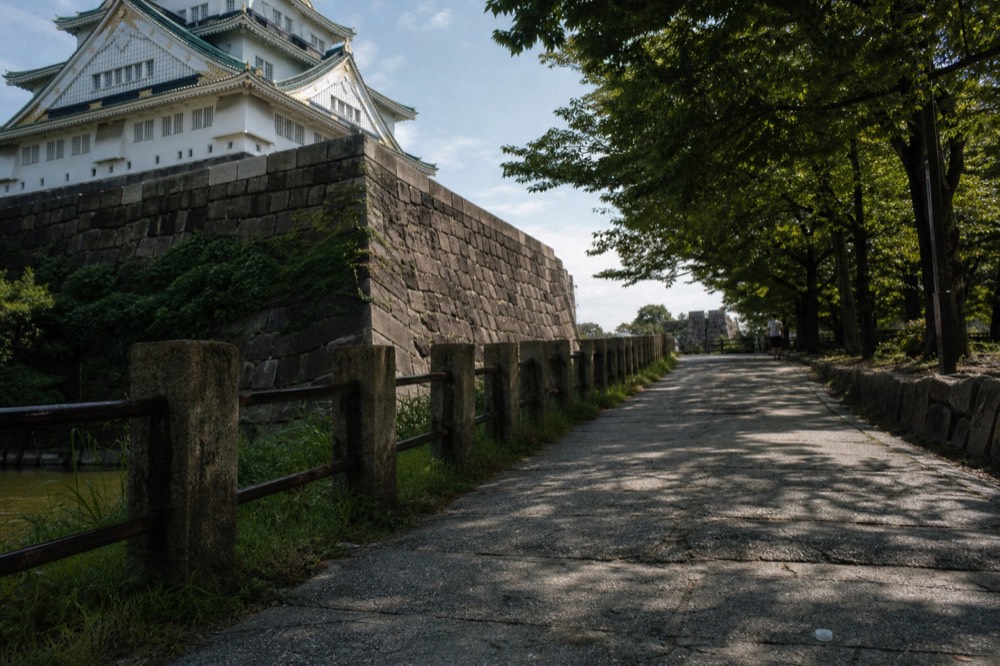 Stone wall and keep foundation seen from the inner moat path