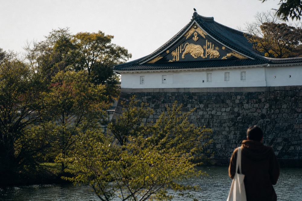 The golden tiger relief on the roof of Osaka Castle against a blue sky