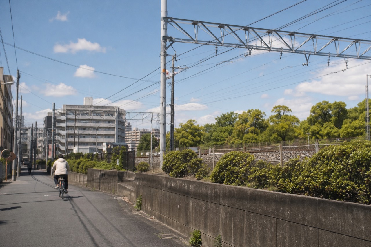 Osaka apartment buildings and railway tracks under a bright sky