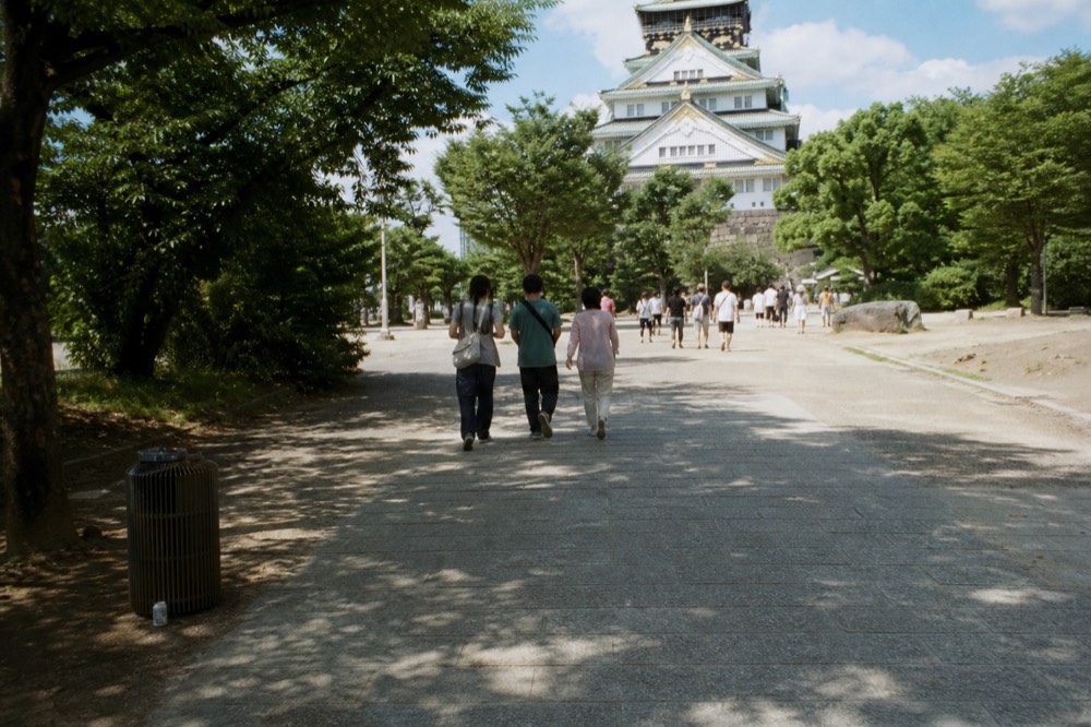Visitors walking the approach path toward the Main Tower entrance