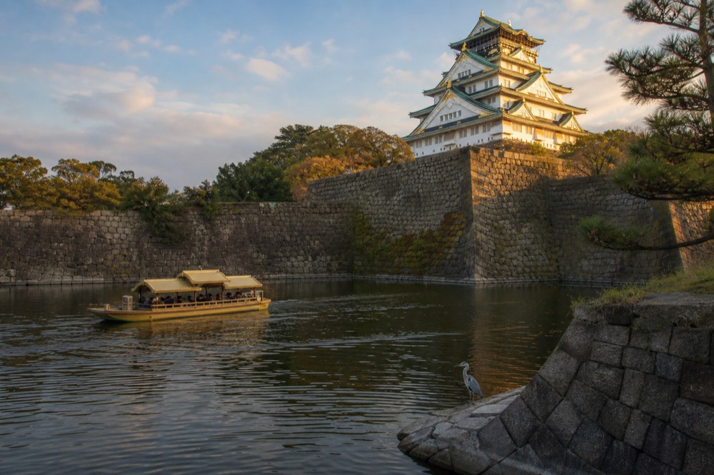 Wide view of the castle tower and inner moat in the late afternoon light