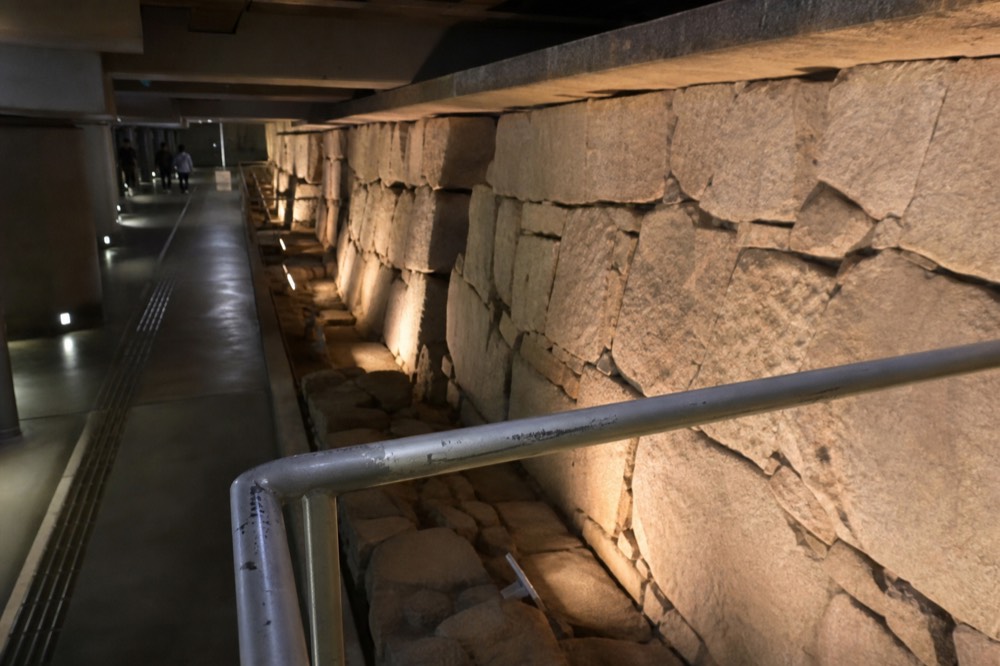 The Toyotomi Stone Wall Museum's underground exhibition hall with the original stone wall lit from below