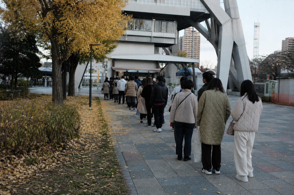 Visitors queuing at the Osaka Castle ticket window on a busy autumn afternoon