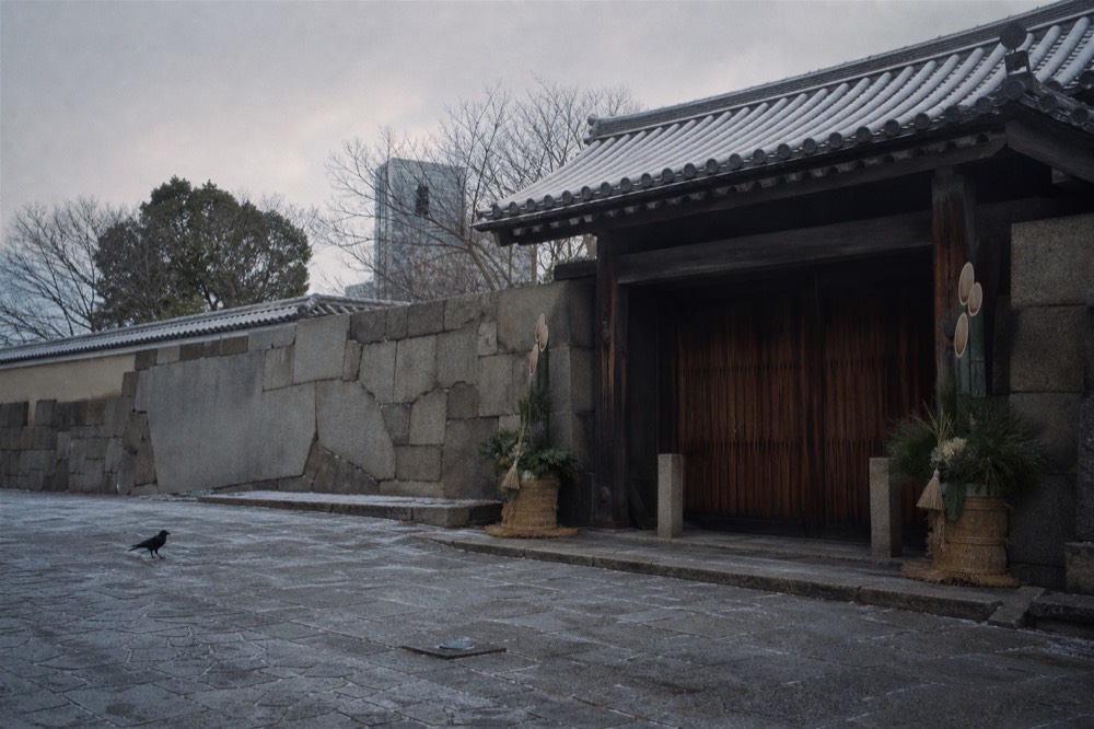 Closed gate of Osaka Castle with New Year decorations visible on the stone wall