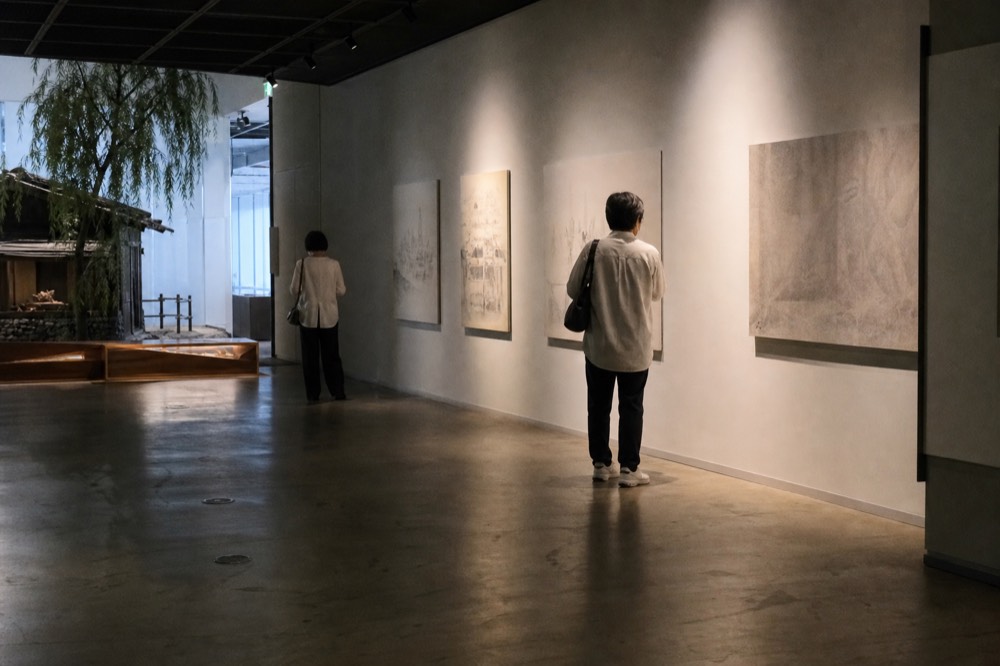 Quiet museum hall with display panels and dim overhead lighting