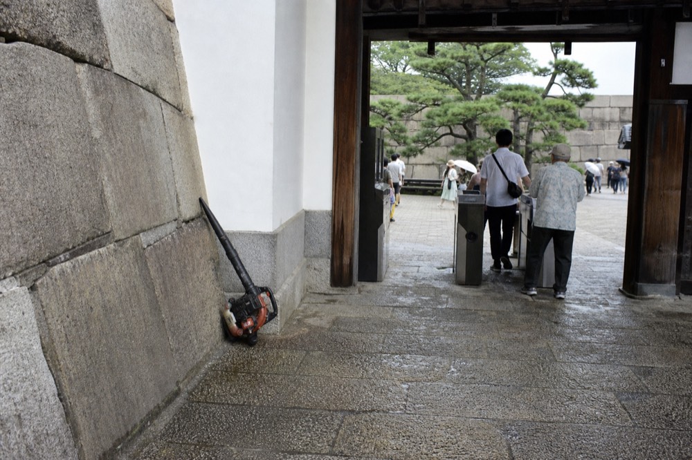 Ticket gate area of a castle museum with visitors passing through in daylight