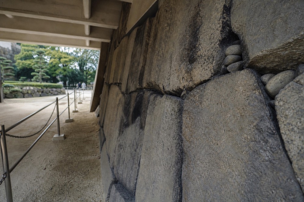 Close view of roughly fitted natural stones forming an old castle wall face